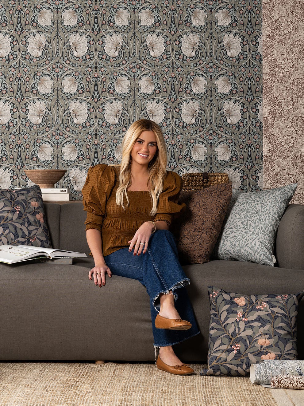 Portrait of Shea McGee in front of wallpaper and pillow cover patterns