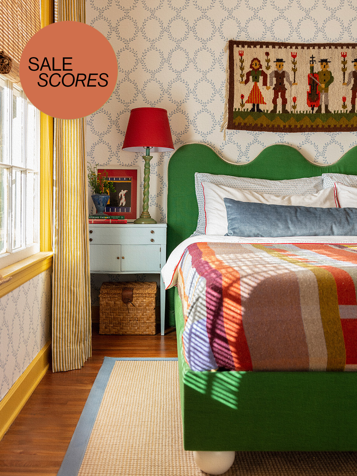 Colorful bedroom with green scalloped headboard and patterned quilt.