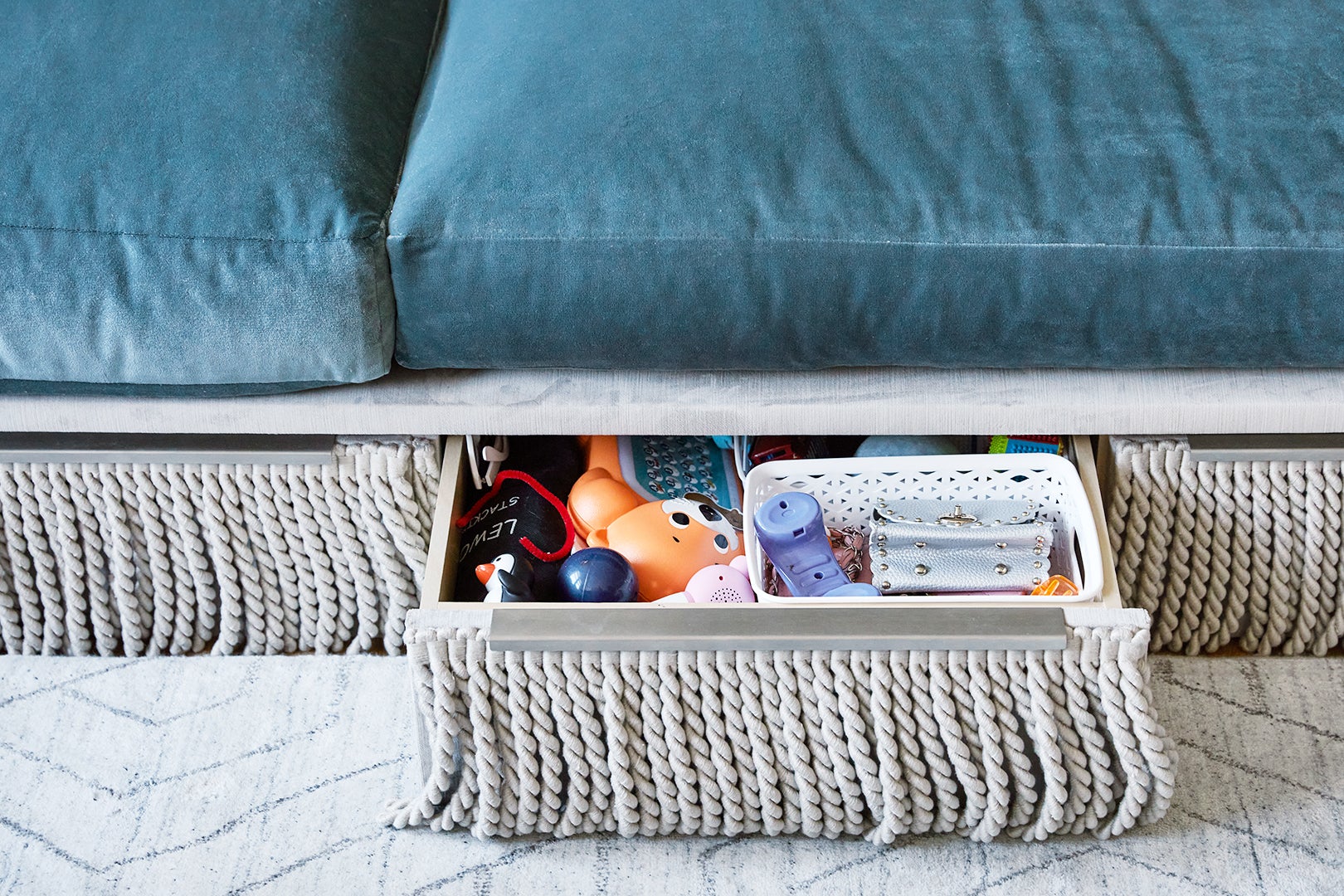 sofa drawer open with toys in it
