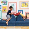 kids playing on navy fort cushions