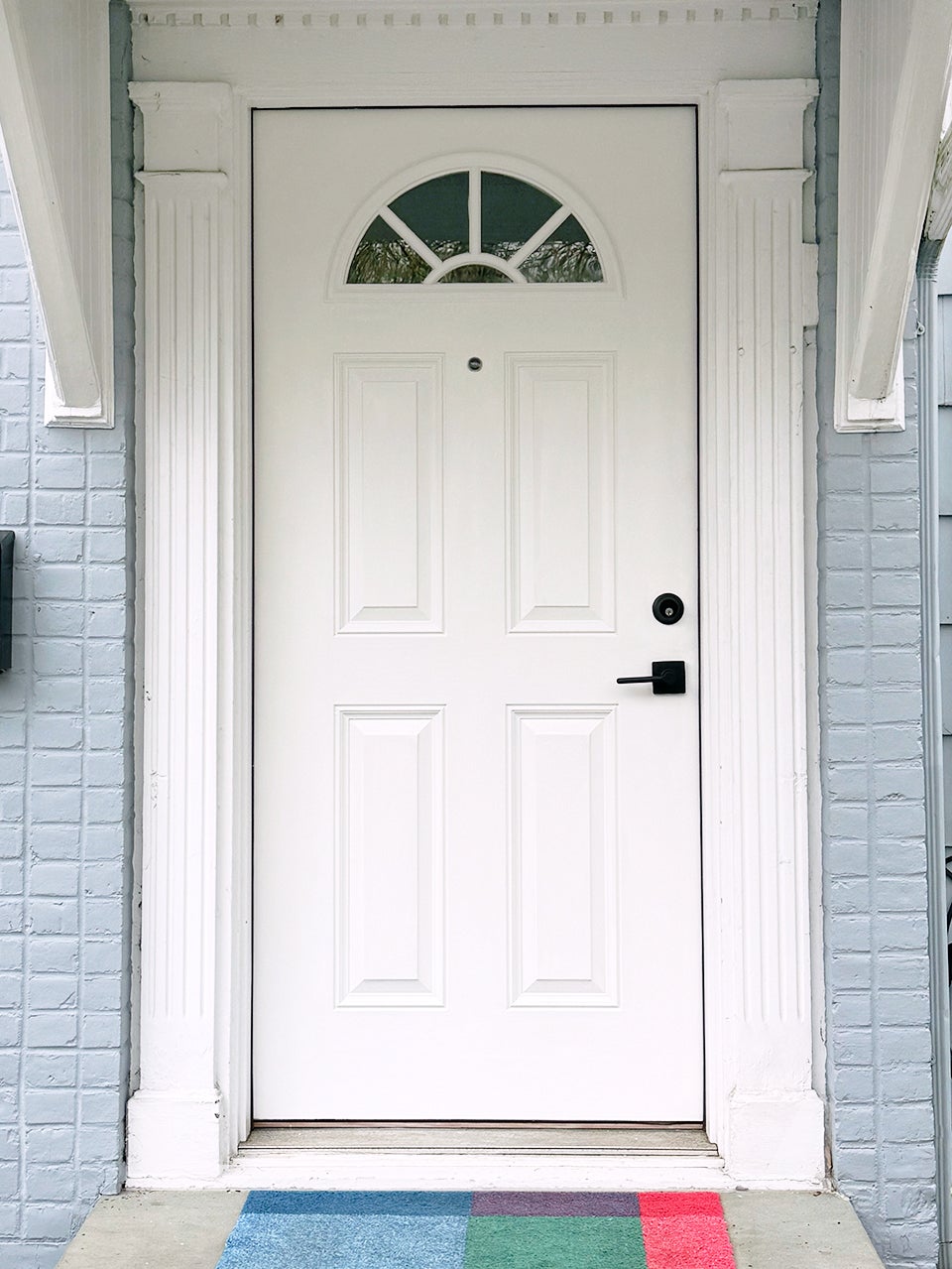 white front door with level lock