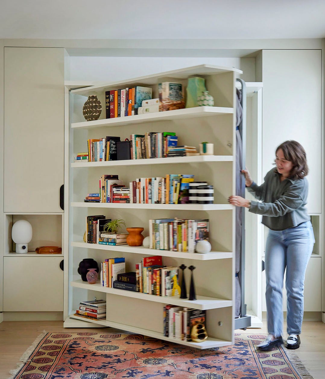 woman shifting bookshelf