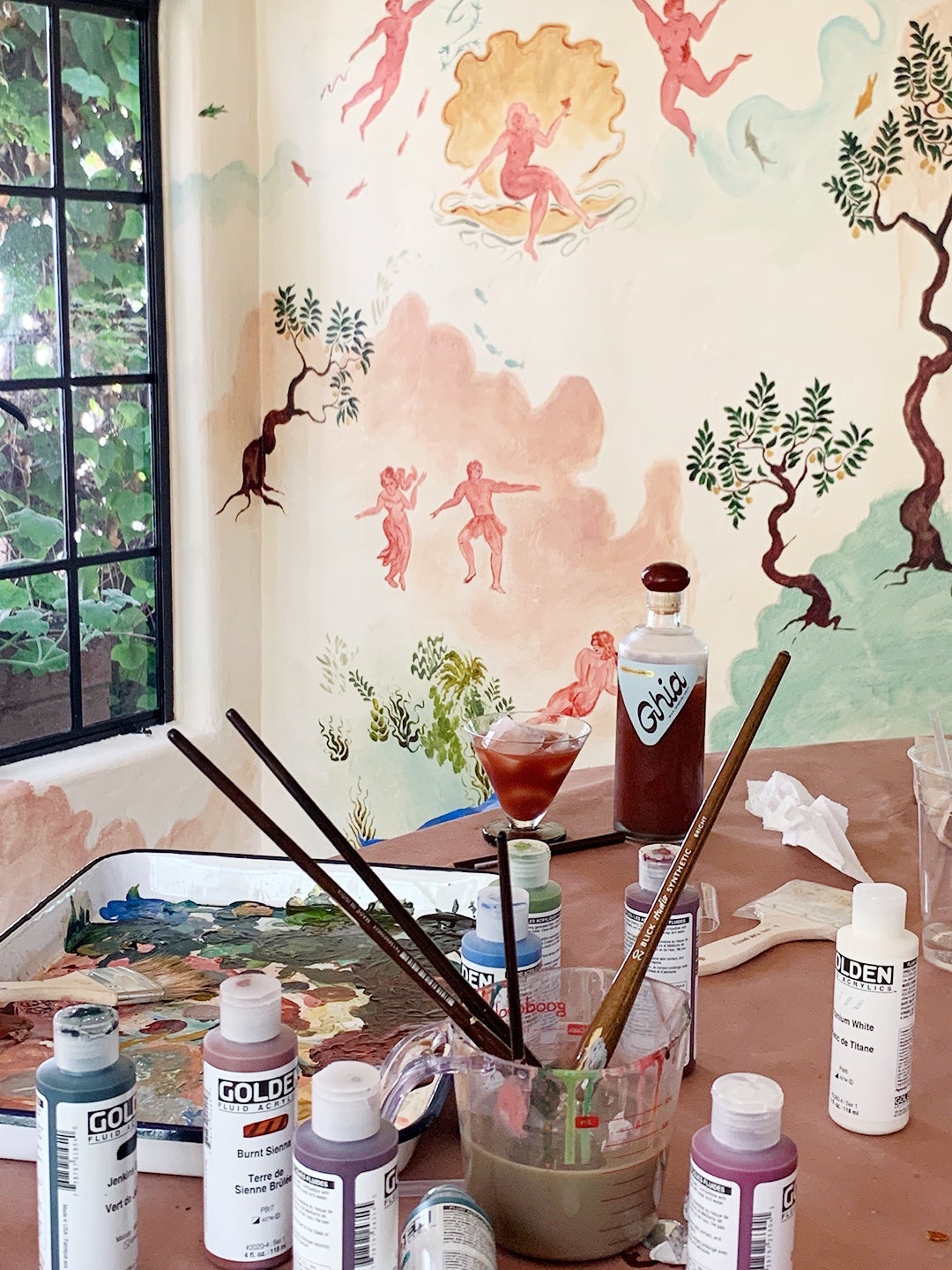 Mural in progress with paintbrushes