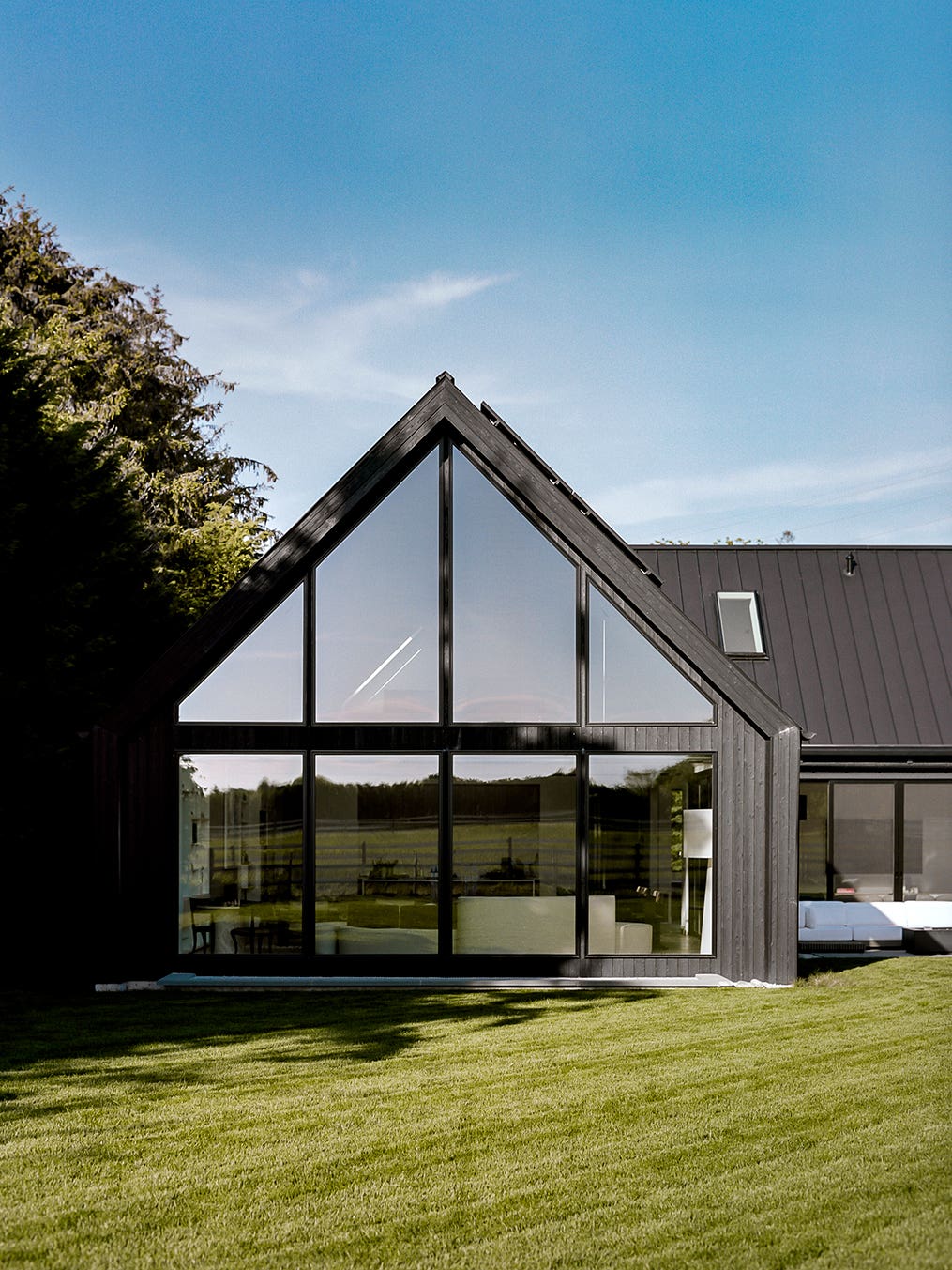 Black a-frame exterior with tons of windows