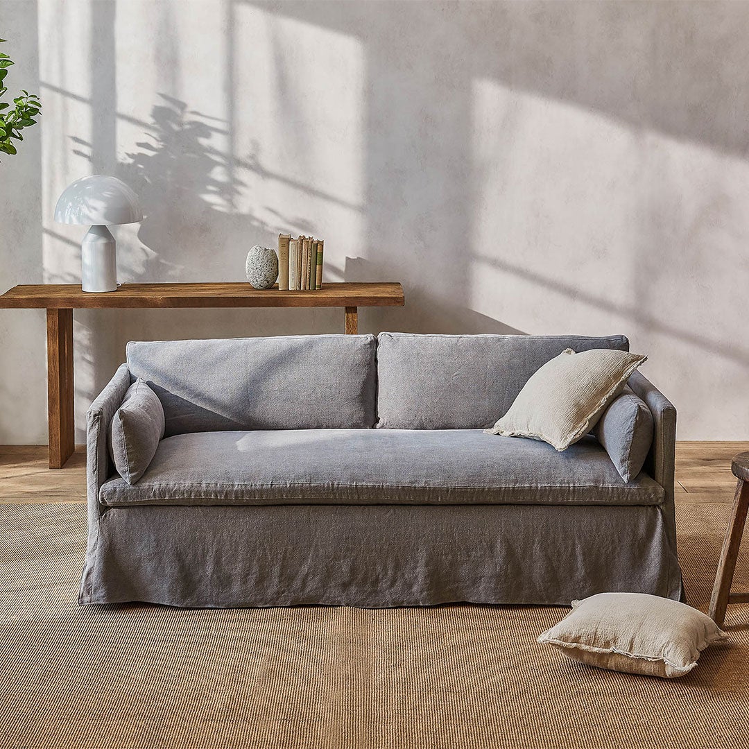 gray slipcovered sofa with lumbar cushions