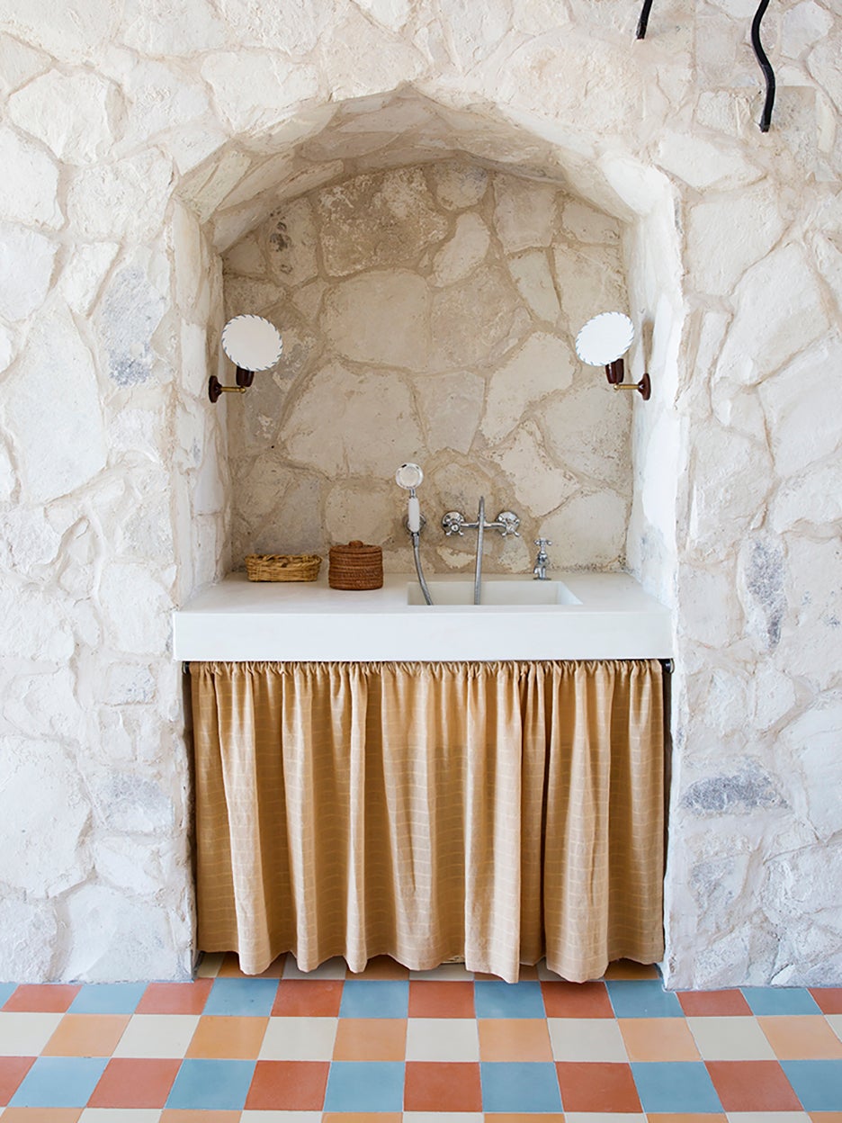 sink nook in stone wall with fabric skirt