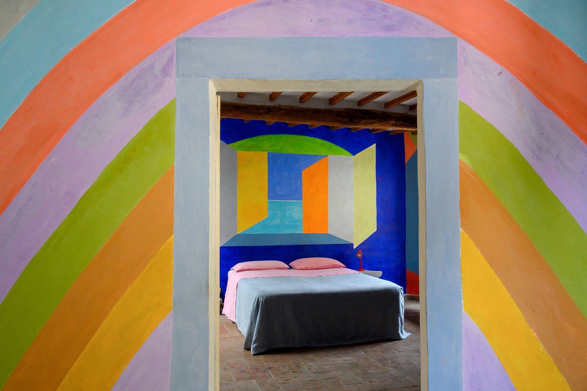 rainbow hallway leading to color-blocked bedroom