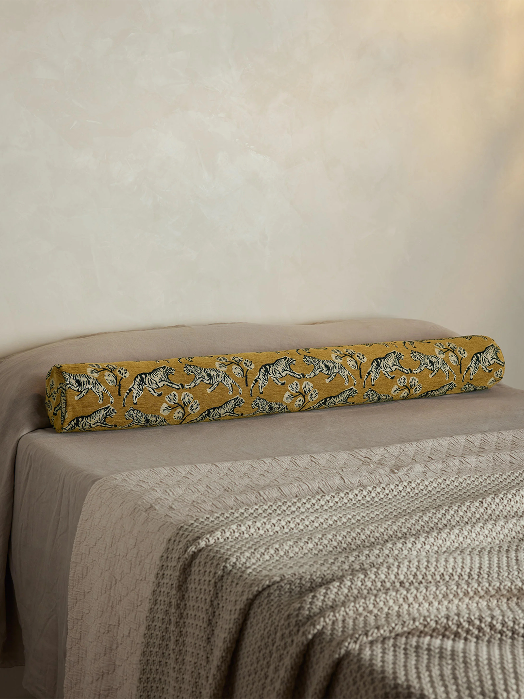 tiger fabric on bolster pillow on bed