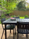 black powder-coated table and chairs in yard