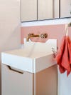 white bathroom sink with wood cabinet