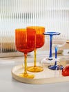 Wine glasses with yellow stems and orange glasses