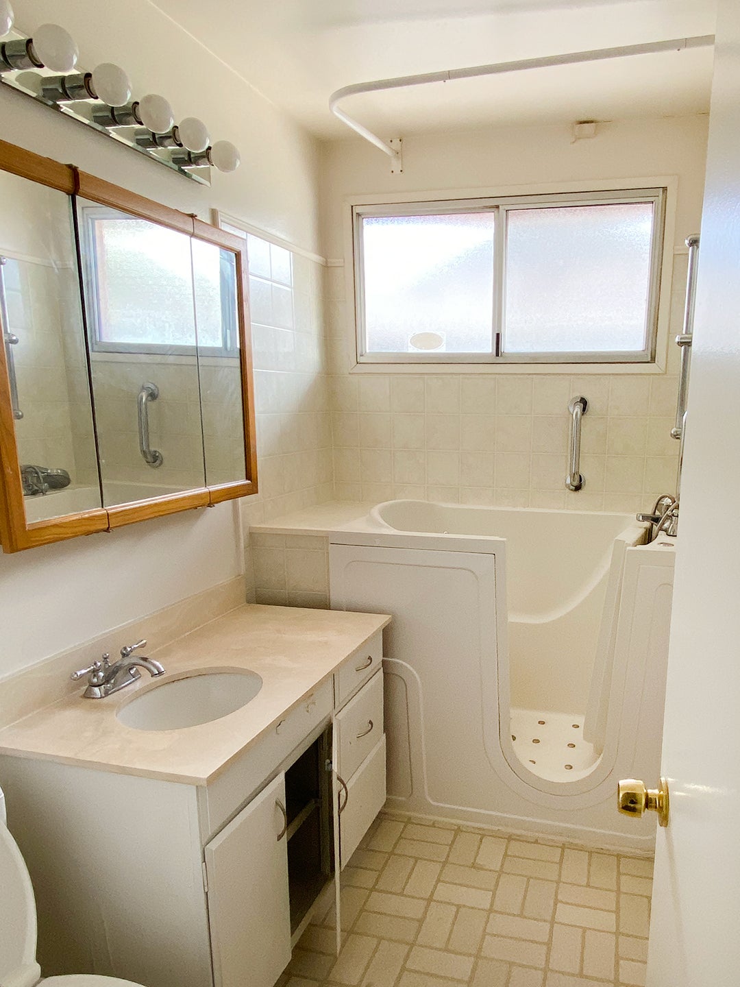 dated bathroom with large tub