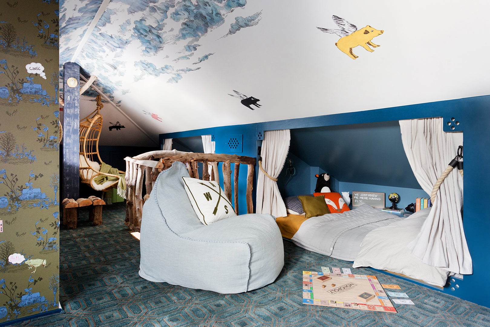 Kids room with flying pigs on wallpaper