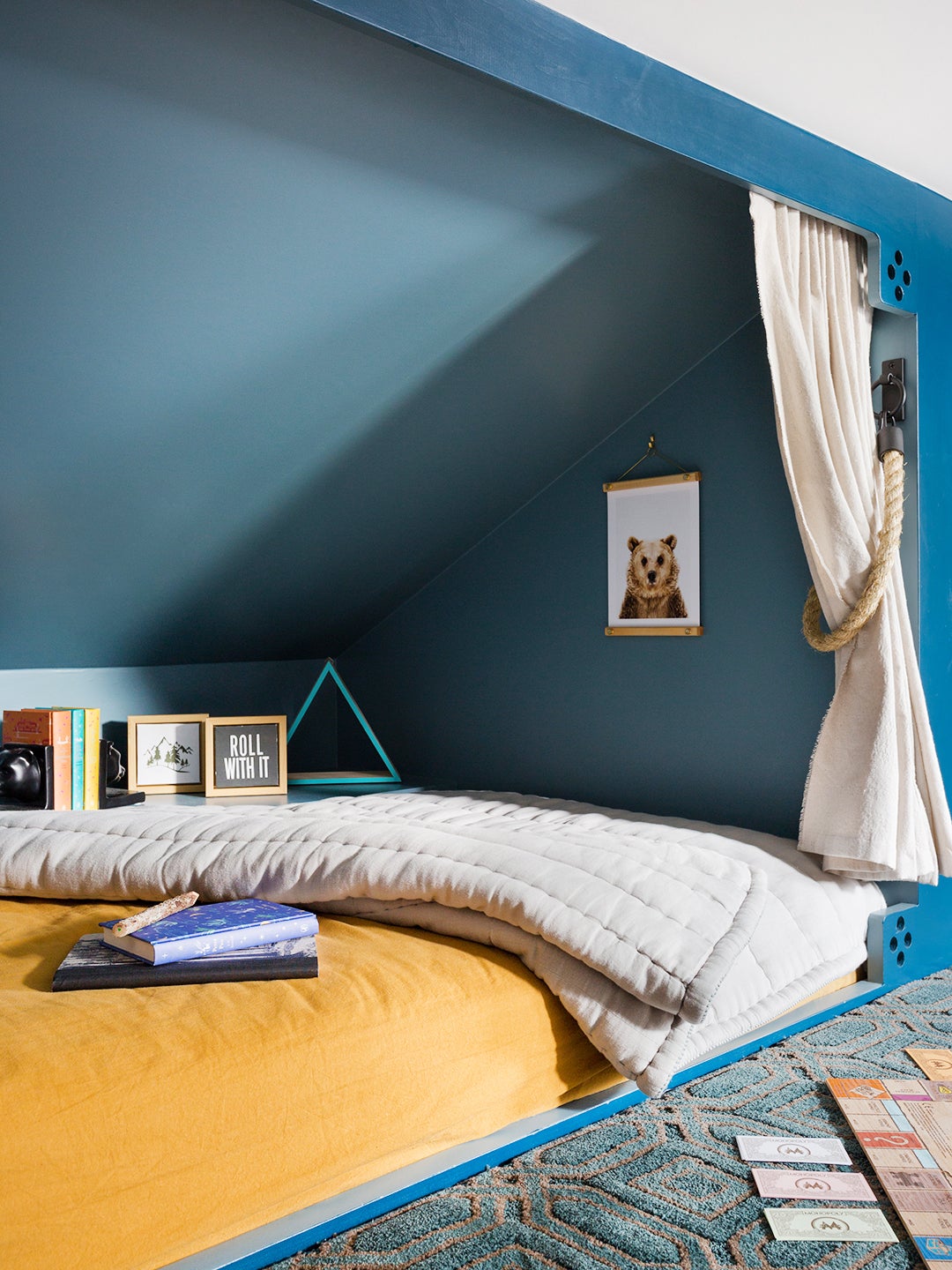Sleeping nook painted blue with yello bedding