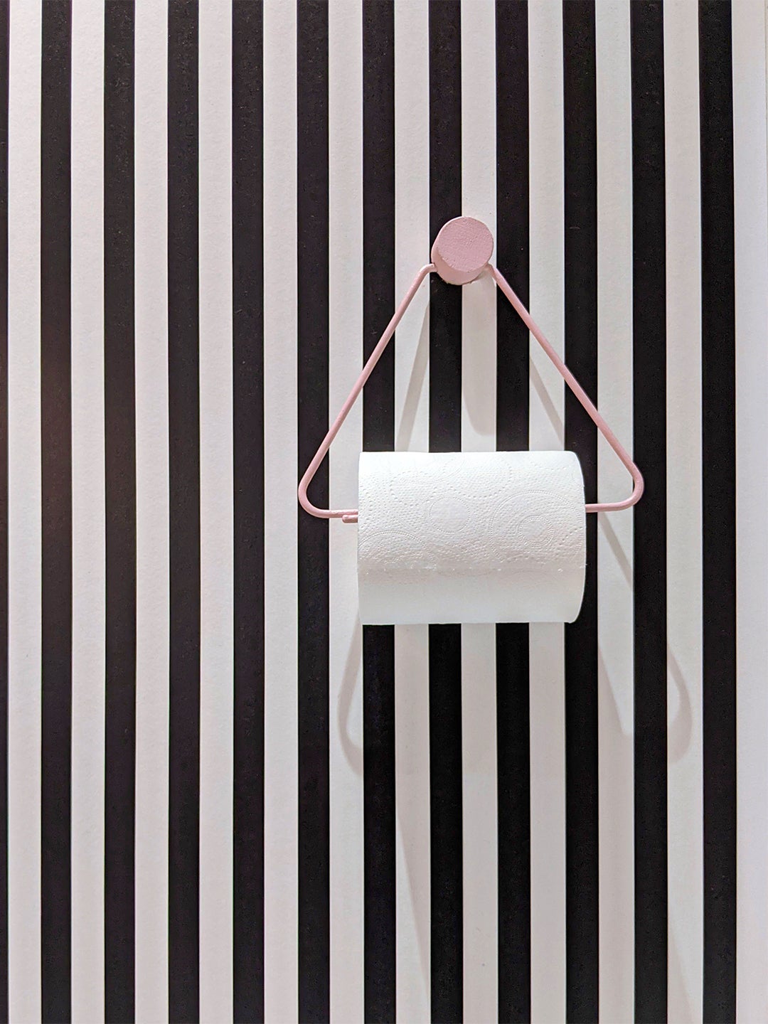 striped wall around toilet paper holder