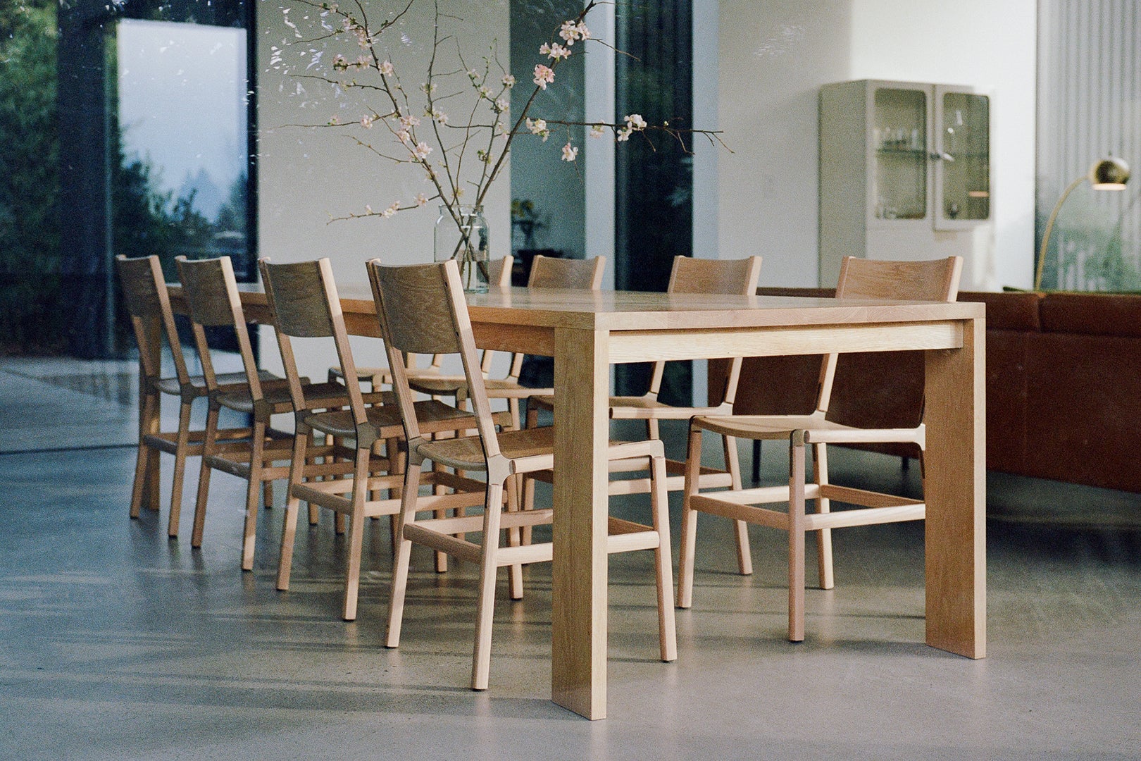 Dining table with wooden Fyrn chairs around it