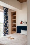 wood shelving cubby next to bed