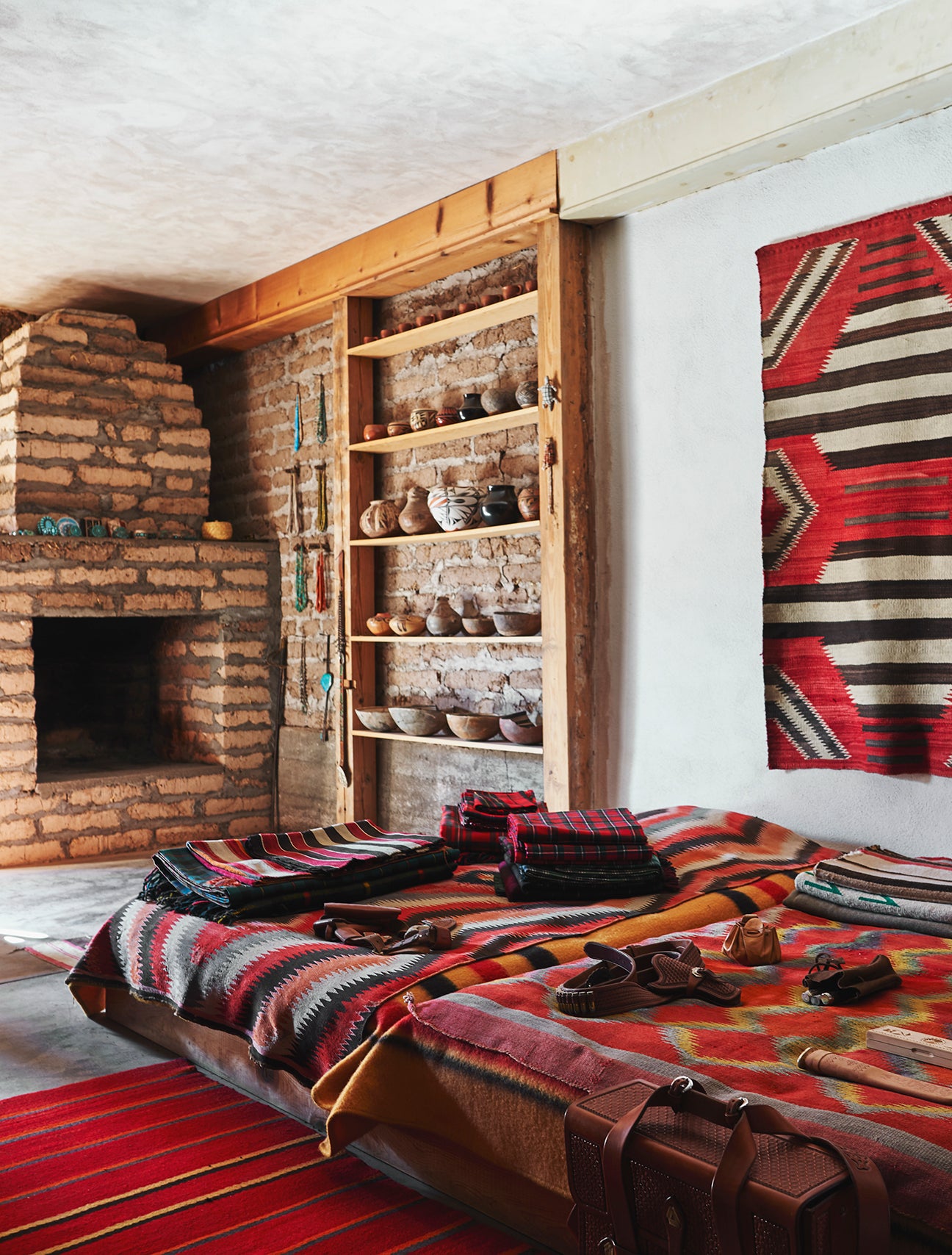 Navajo blankets next to brick fireplace