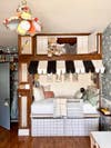 kid's bed nook with striped awning