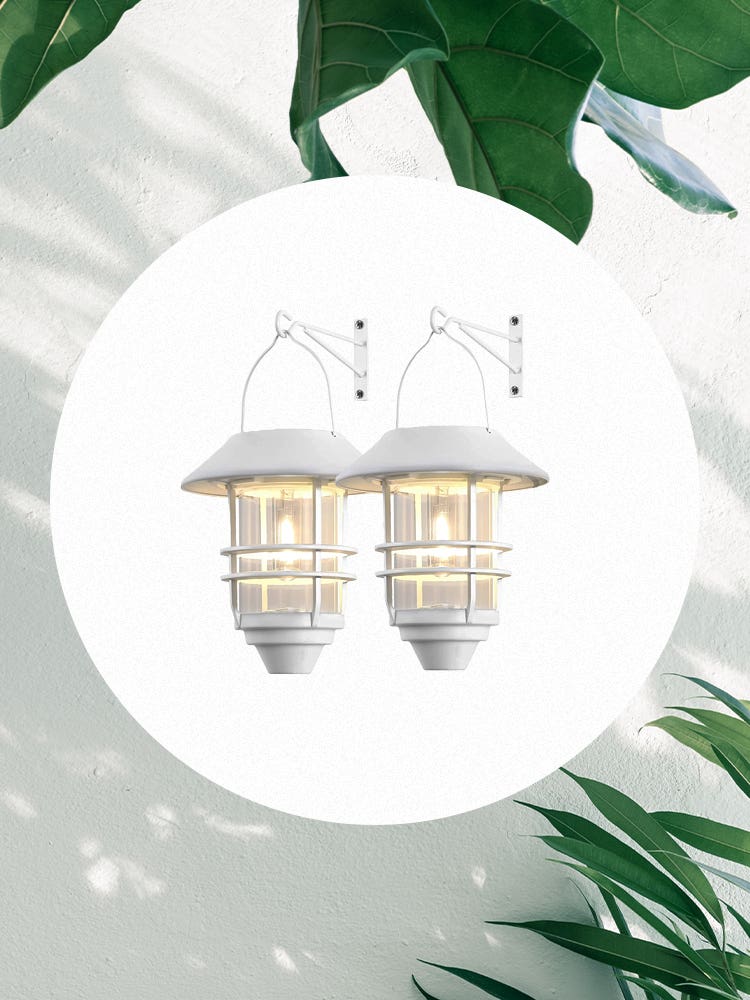 pair of white solar lanterns on leafy background