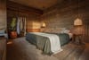 Bedroom with concrete walls and sage green bedding