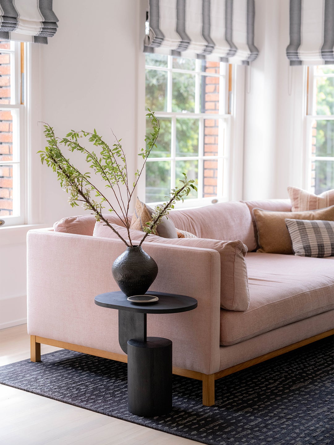 Pink sofa with black side table