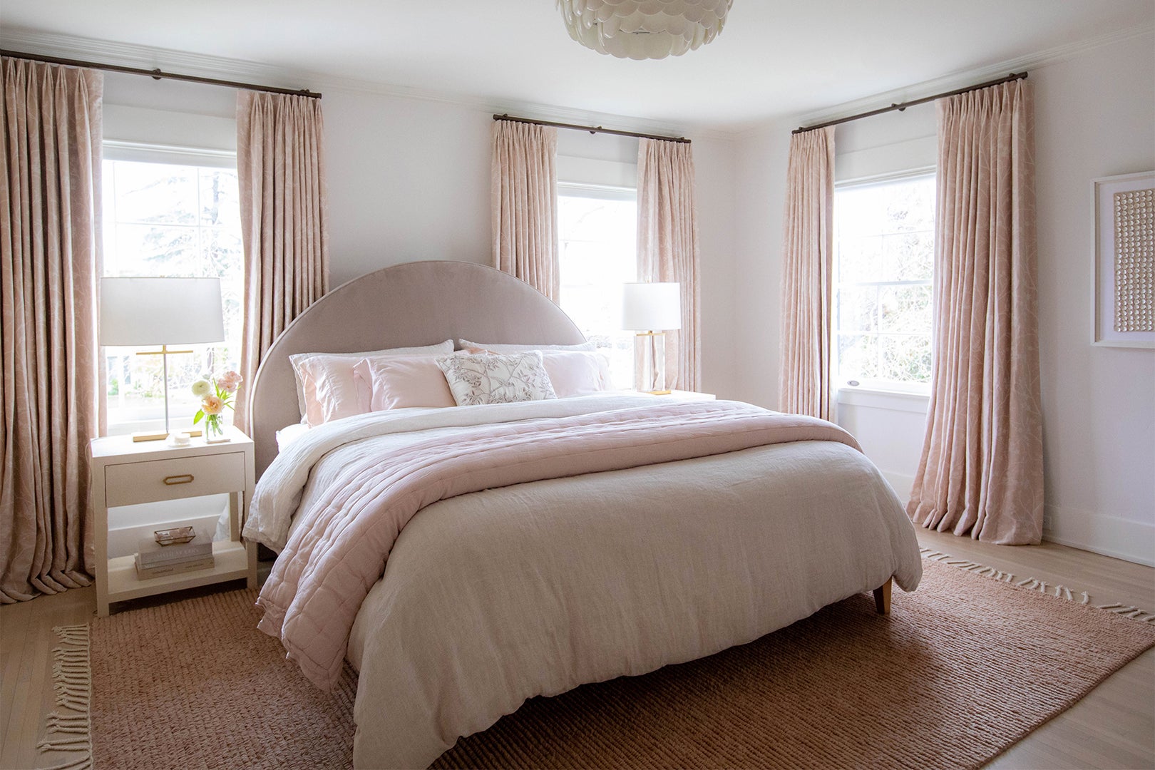Bedroom with pink curtains and white and pink bedding