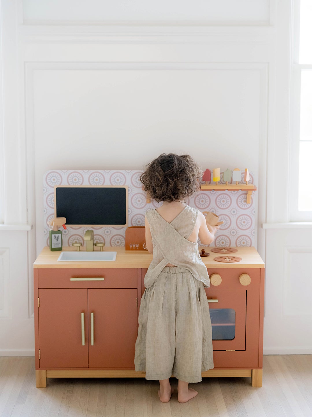 Boy playing with a play kitchen