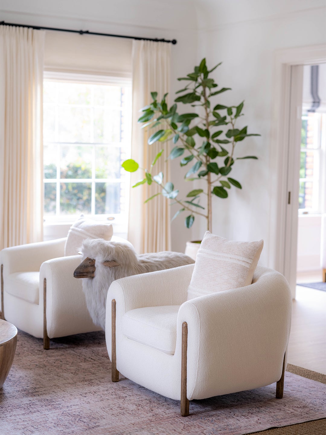White chairs in a living room with sheep