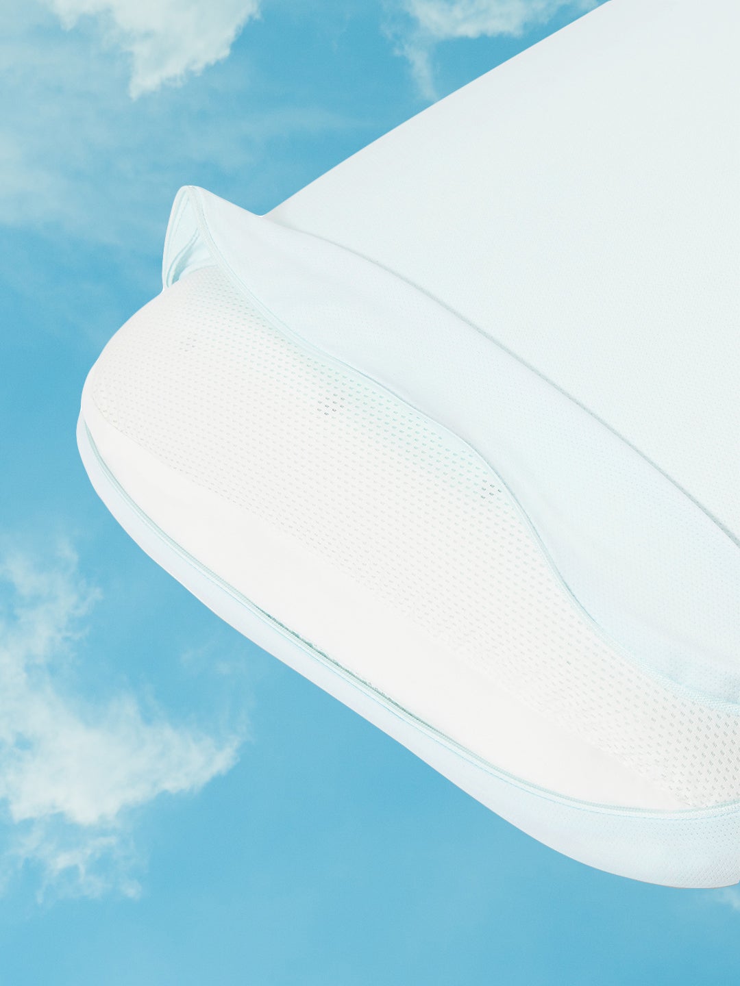 detail shot of Casper hybrid pillow with snow technology's blue cover unzipped on cloudy sky background