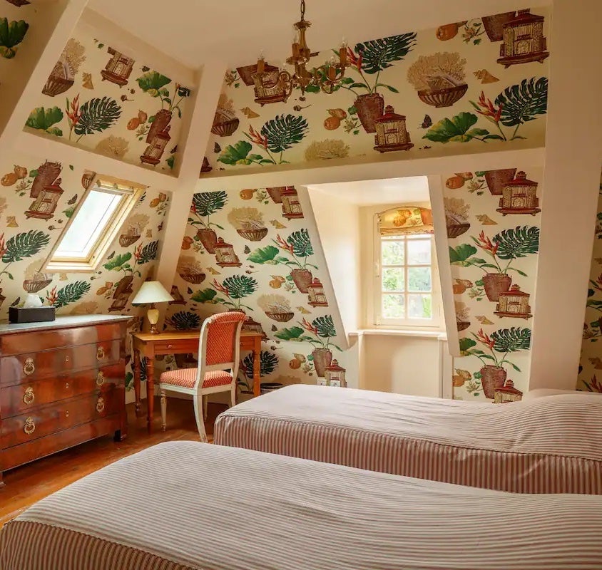 botanical wallpapered bedroom in castle