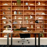 Office with a wall of wood bookshelves