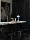 Edge of marble bar with bar strools