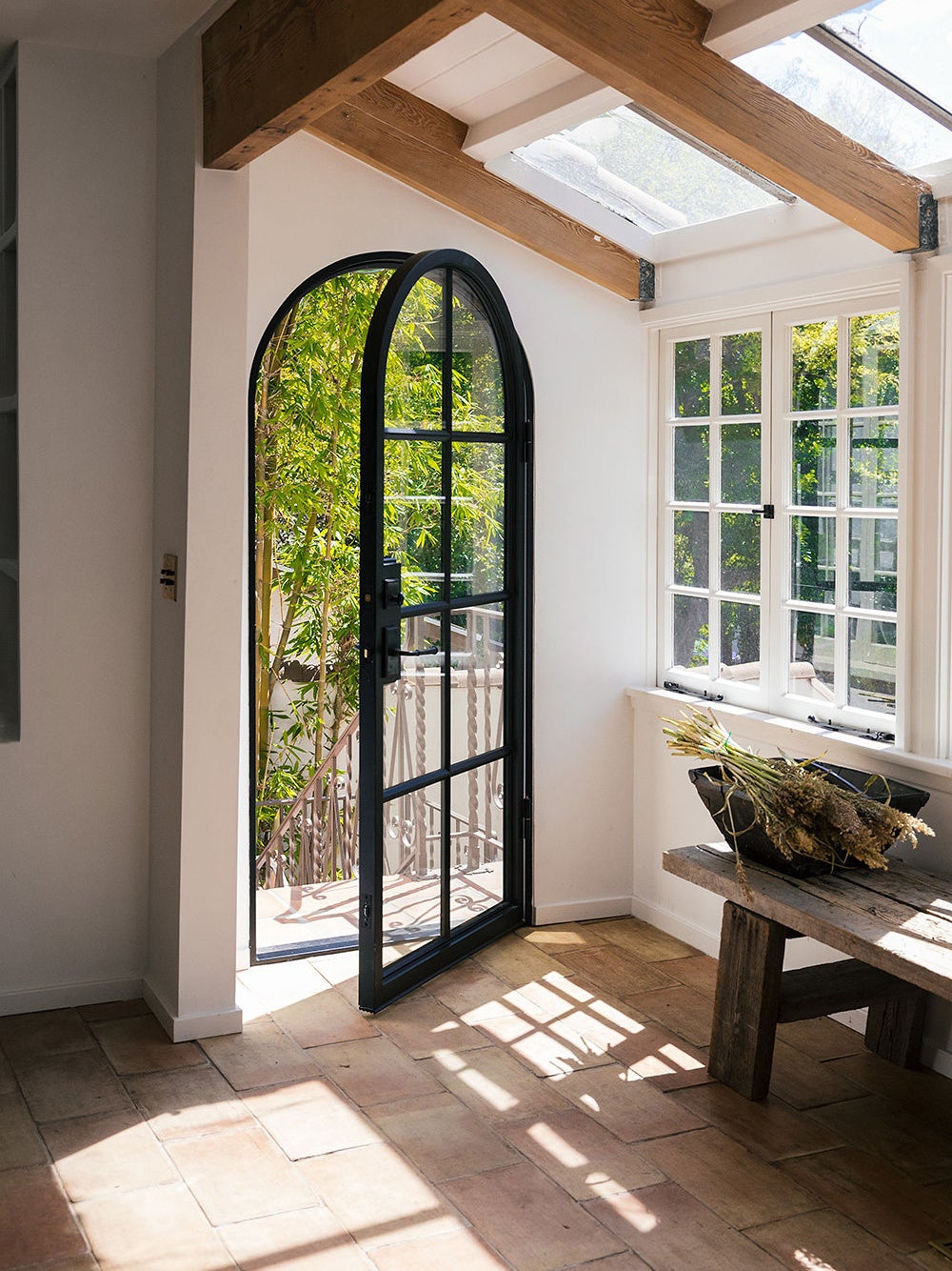 A black arched doorway into a home