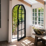 A black arched doorway into a home