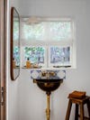 Powder room with copper sink and vintage tiles
