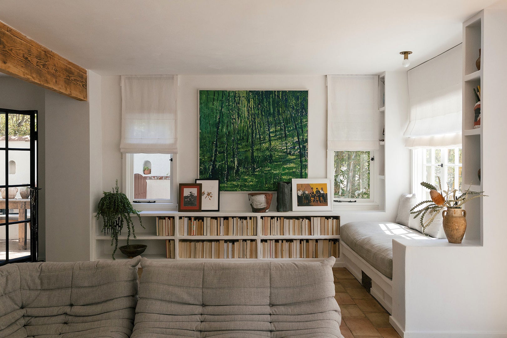 Gray Togo Sofa with bookshelf in background