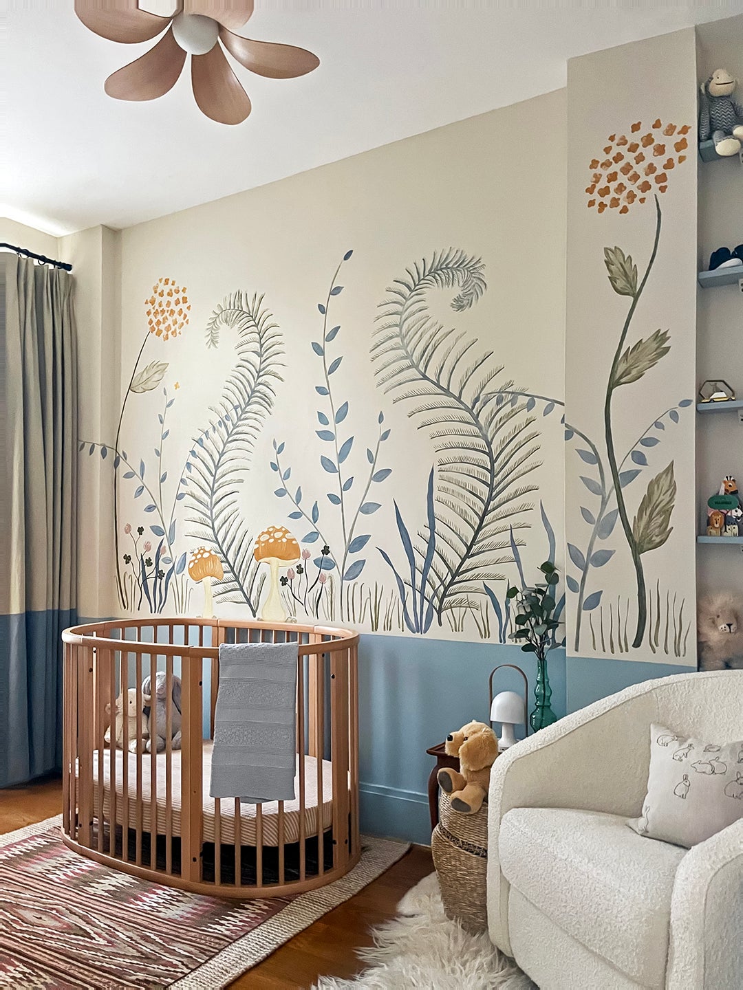 nursery with botanical mural and blue half wall
