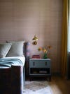 bedroom with pink grasscloth wallpaper