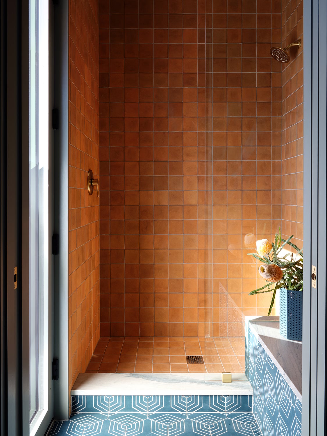 amber-tiled shower stall
