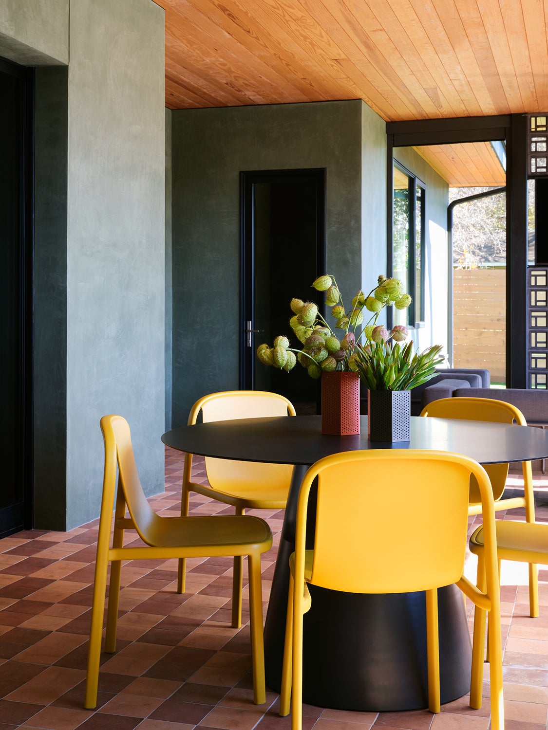 black round dining table with yellow chairs
