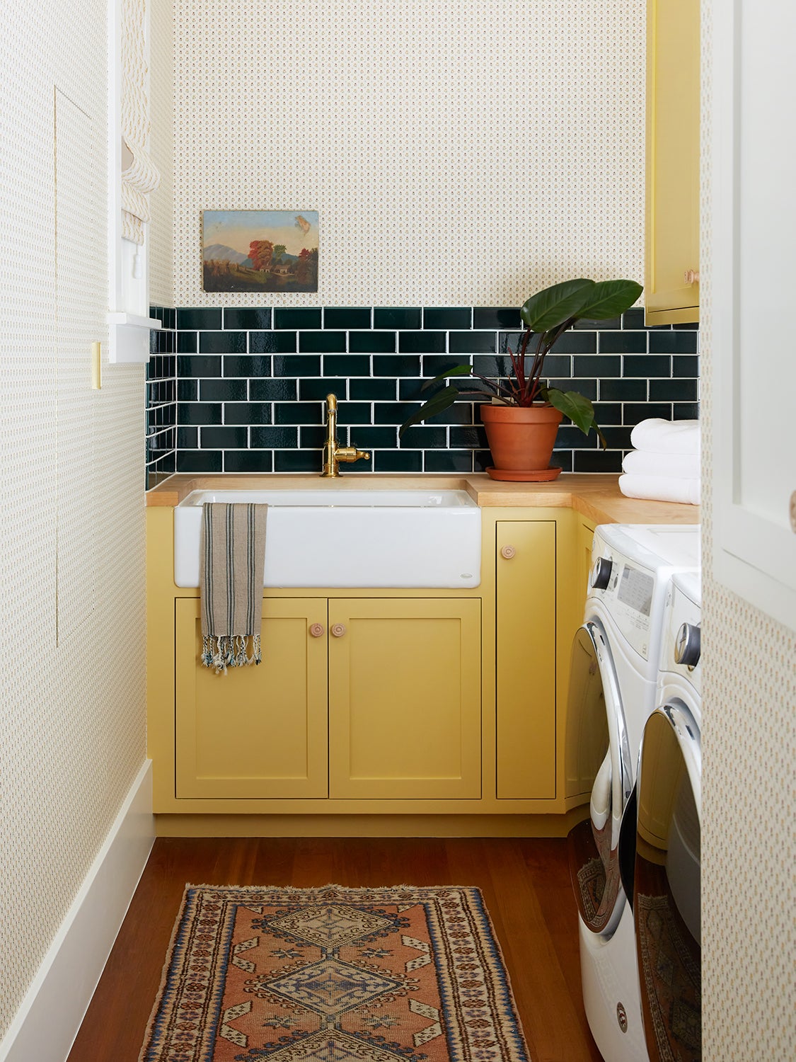 Yellow cabinets in a laundry room