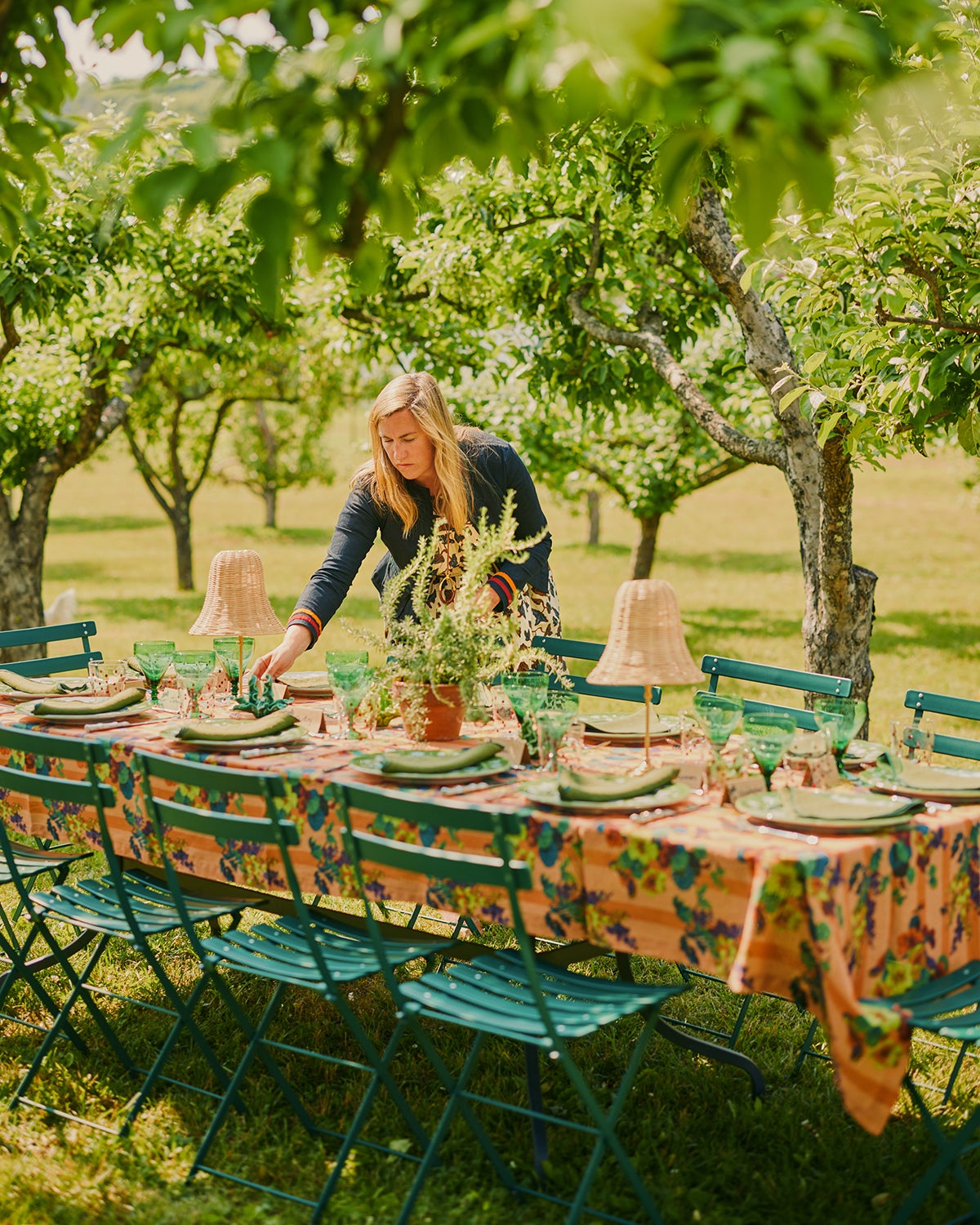 Woman setting up an outdoor table in a field