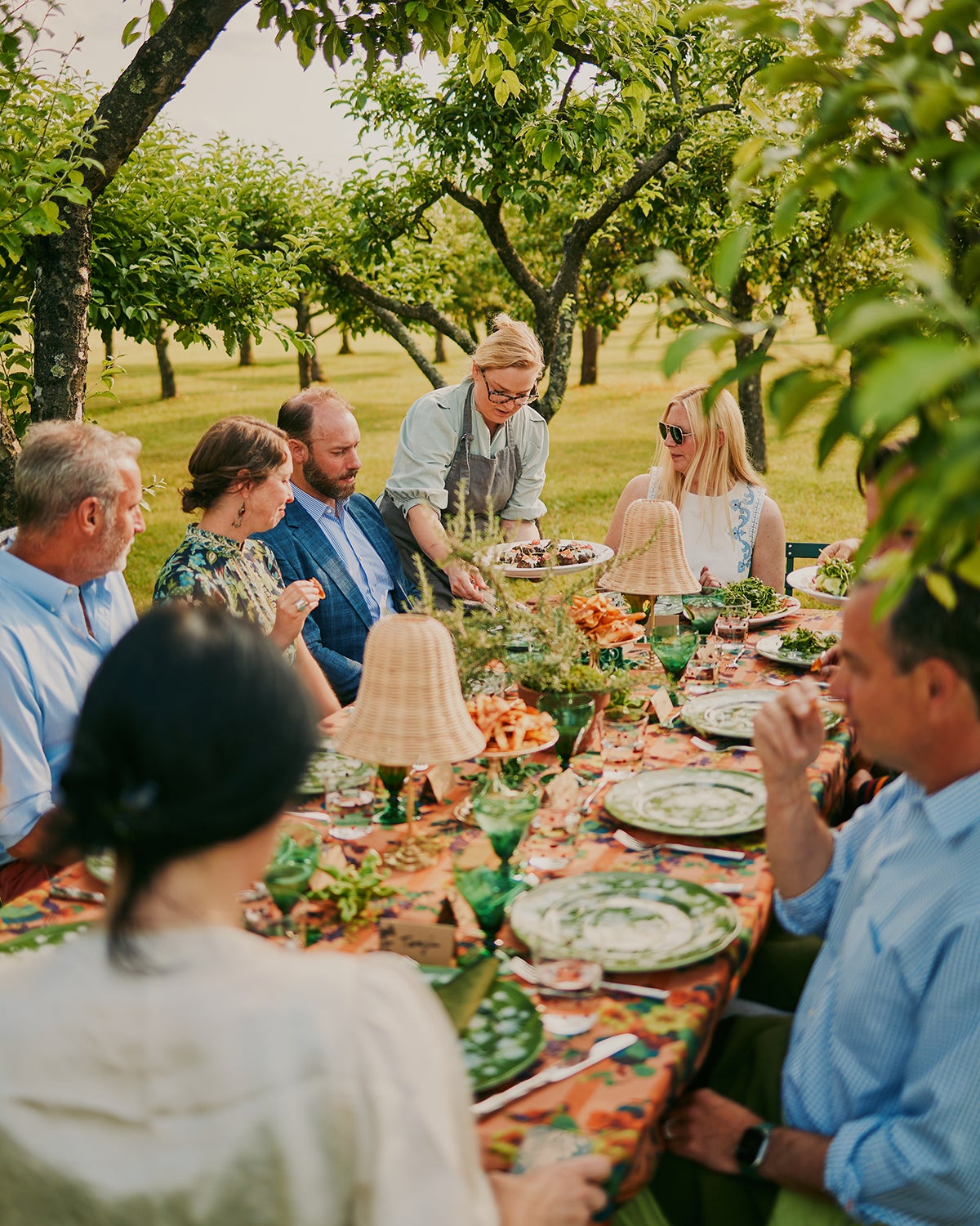 Guests eating at a table in a field