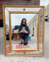 Woman taking selfie in mirror at a French flea