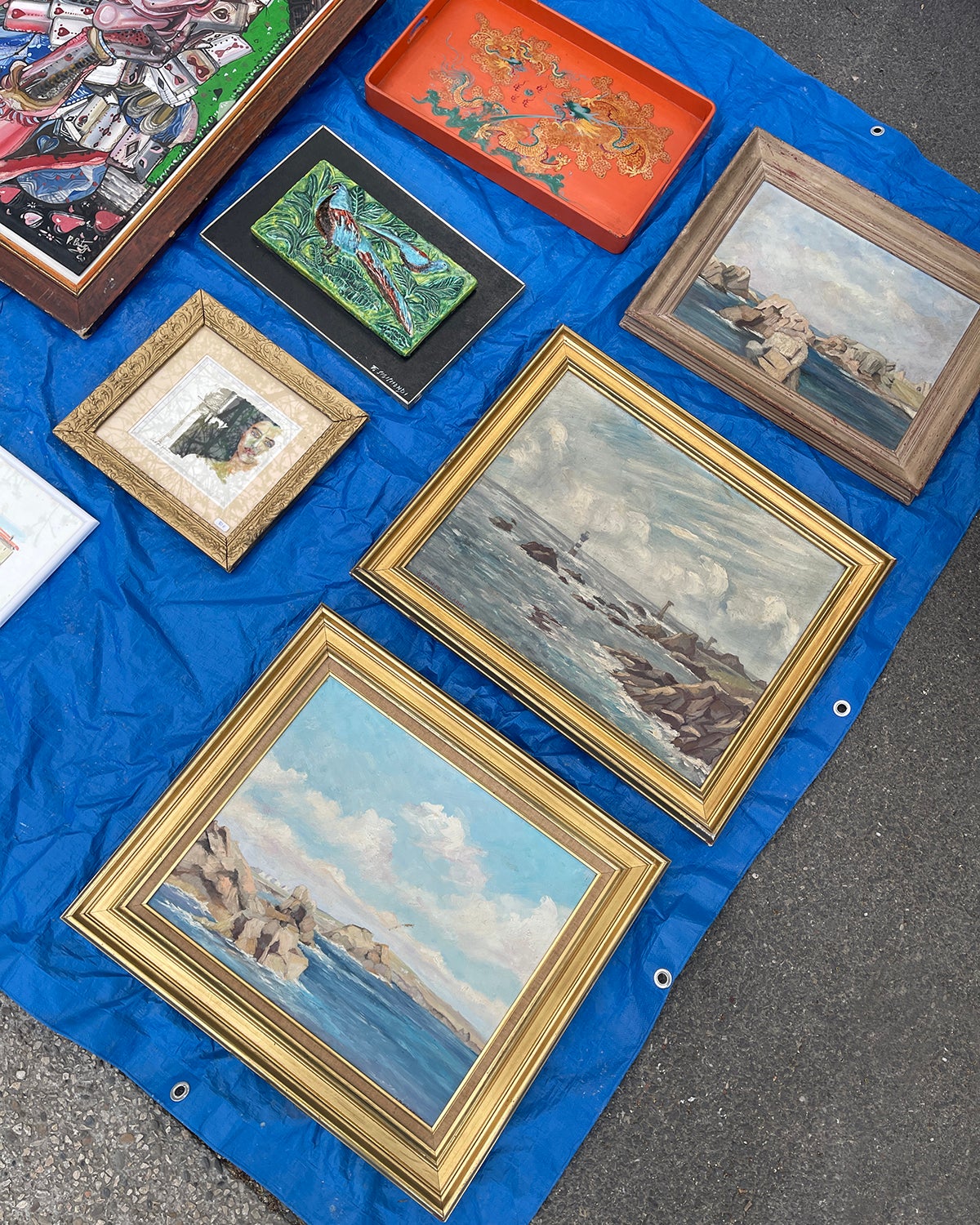 Framed artwork on a table at a flea market