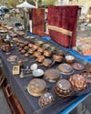 Table full of copper pots at a flea market