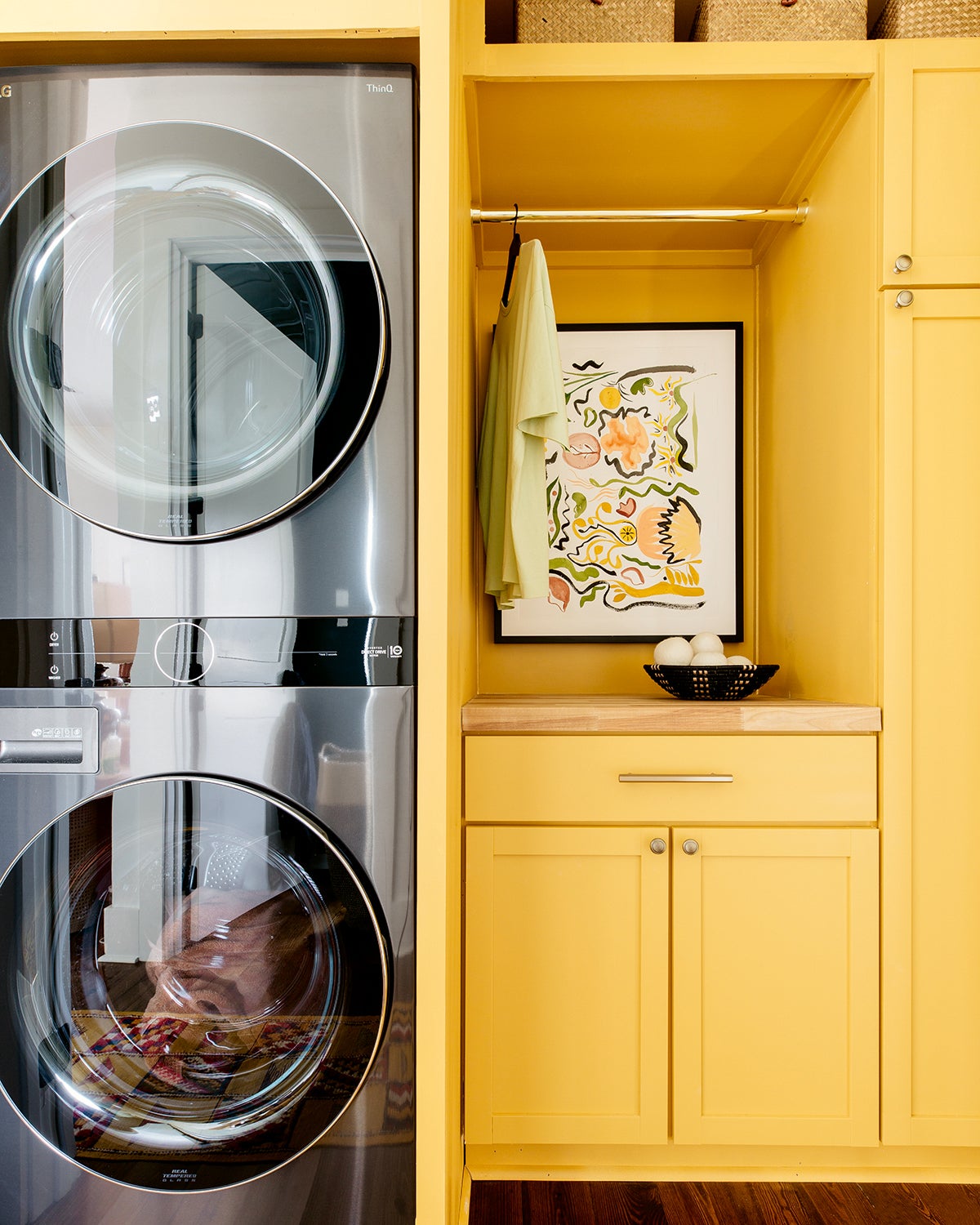 Laundry room with yellow cabinets