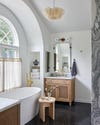 airy bathroom with small wood vanity