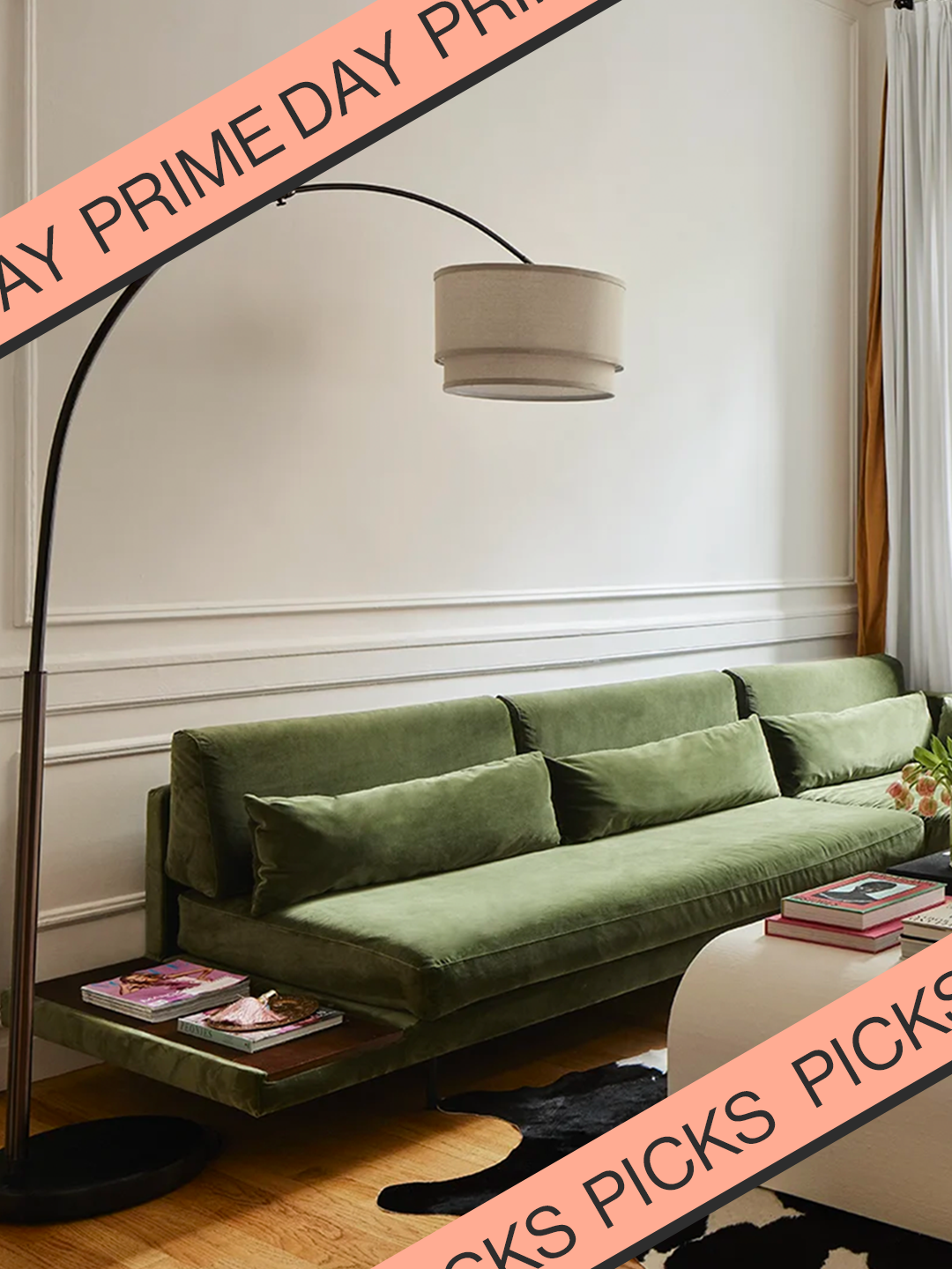 green velvet couch in living room with arched bronze lamp curved overhead in Brynn Whitfield's living room with Prime Day banner.